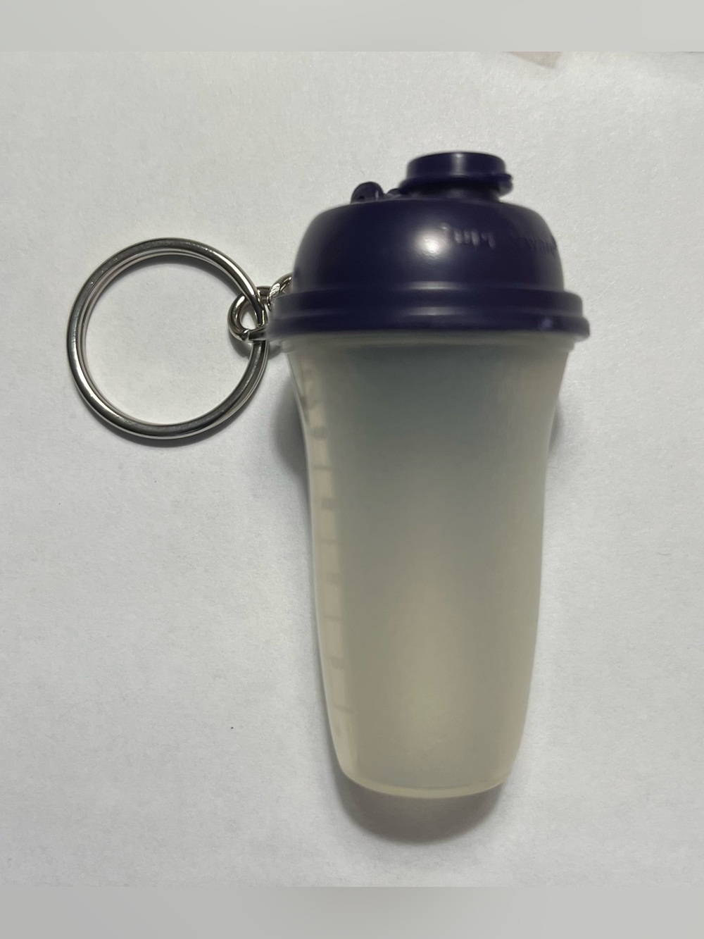 1 Tupperware Mini Shaker Bottle Keychain. Approximately 2 1/2 inches tall.